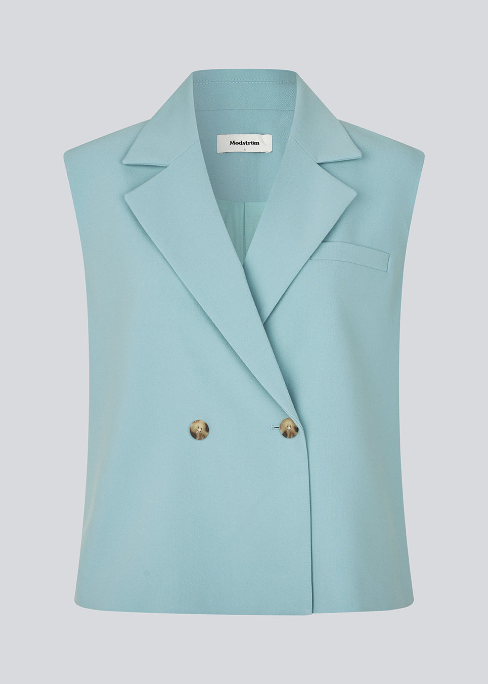 Loose blue vest with a collar in our classic gale material. Galemd vest is sleeveless and has a front button closure. 