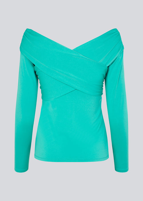 Long-sleeved top in turquoise in a soft quality. GeorgiaMD wrap top has a slim silhouette and a slight off-shoulder-effect with a draped wrap look at the top. The model is 175 cm and wears a size S/36.
