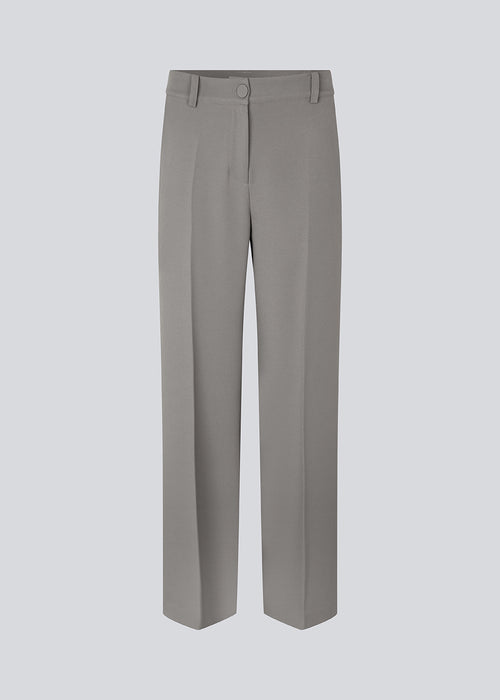 Tailored pants with wide, straight legs with creases in front and back. GrayMD pants have a high waist with a zip fly and fabric-covered button. Lined. The model is 175 cm and wears a size S/36.