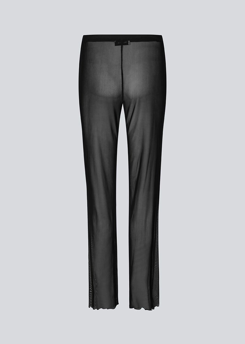 Straight pants with transparent look in stretchy material. GwenMD pants are detailed with lettuce hems in front and bottom hem. Medium waist with covered elastication. The model is 175 cm and wears a size S/36.