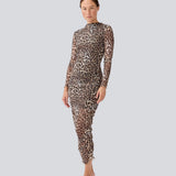 GwenMD top is a tight-fitted mesh top with gatherings in front. The top has a wide neckline and long sleeves, that are slightly more transparent than the body. The model is 175 cm and wears a size S/36.
