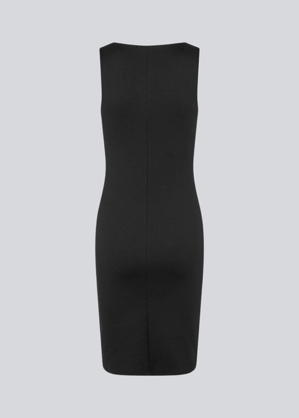 Figure-hugging dress in black with a high boat neck. HakanMD dress is sleeveless, and a midi length cutting at the knees.<br>