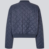 Lightly padded jacket in a quilted material with a short, ribbed collar, and zipper in front. HankMD jacket has a short and loose fit. Made from recycled nylon.