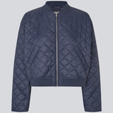 Lightly padded jacket in a quilted material with a short, ribbed collar, and zipper in front. HankMD jacket has a short and loose fit. Made from recycled nylon.