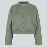 Lightly padded jacket in a quilted material with a short, ribbed collar, and zipper in front. HankMD jacket has a short and loose fit. Made from recycled nylon. The model is 175 cm and wears a size S/36.
