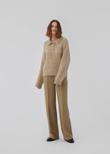 Knitted jumper made from a wool and alpaca blend. HardwickMD polo has a loose fit with collar and buttons in front, dropped shoulders, and long sleeves with a smaller, ribbed cuff. The model is 175 cm and wears a size S/36.