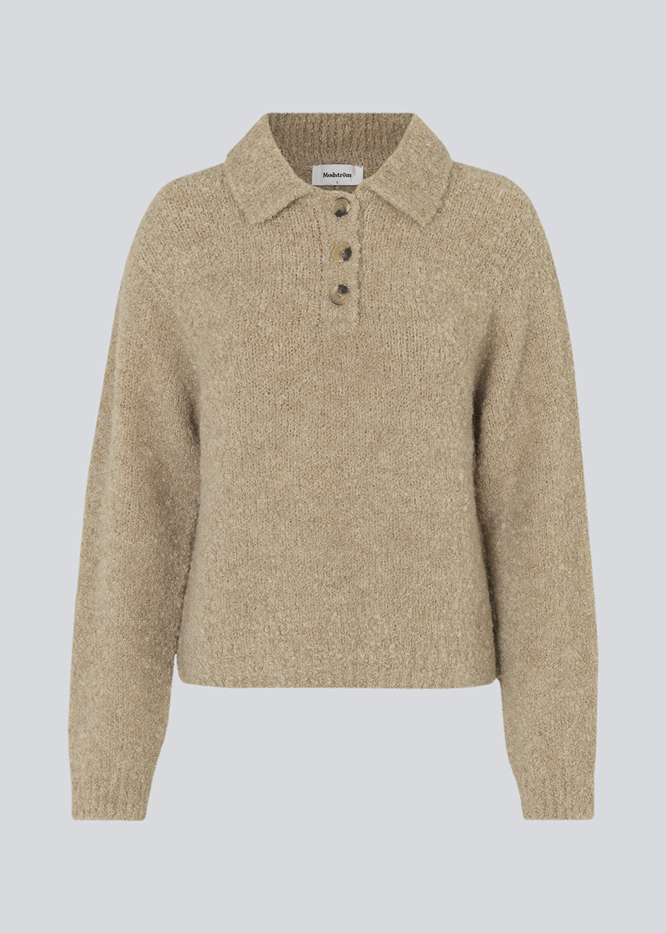 Knitted jumper made from a wool and alpaca blend. HardwickMD polo has a loose fit with collar and buttons in front, dropped shoulders, and long sleeves with a smaller, ribbed cuff. The model is 175 cm and wears a size S/36.