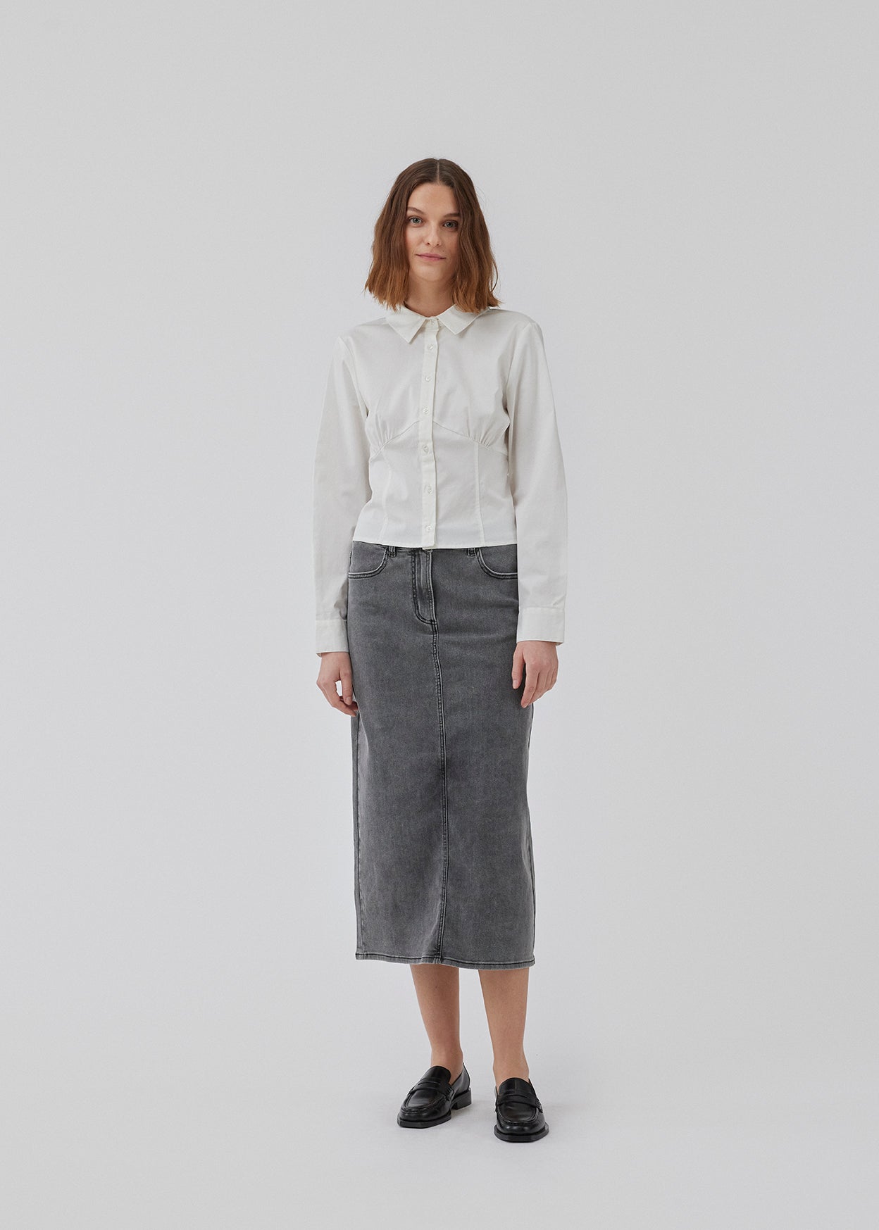 Form-fitting shirt in white in a woven cotton blend with collar, buttons in front, and long sleeves with cuff. HarrisonMD shirt has darts and a cutline below the chest for a corset-inspired look. The model is 175 cm and wears a size S/36.