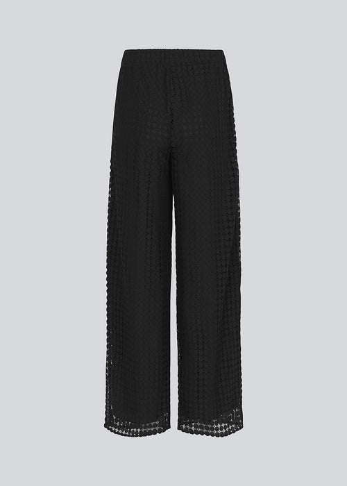 HattieMD pants in black are made from a transparent lace material. The pants have a loose fit with straight legs and a medium elasticated waist. Lined. The model is 175 cm and wears a size S/36.