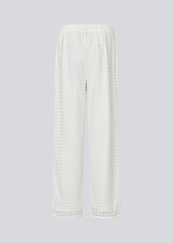 HattieMD pants in white are made from a transparent lace material. The pants have a loose fit with straight legs and a medium elasticated waist. Lined. The model is 175 cm and wears a size S/36.