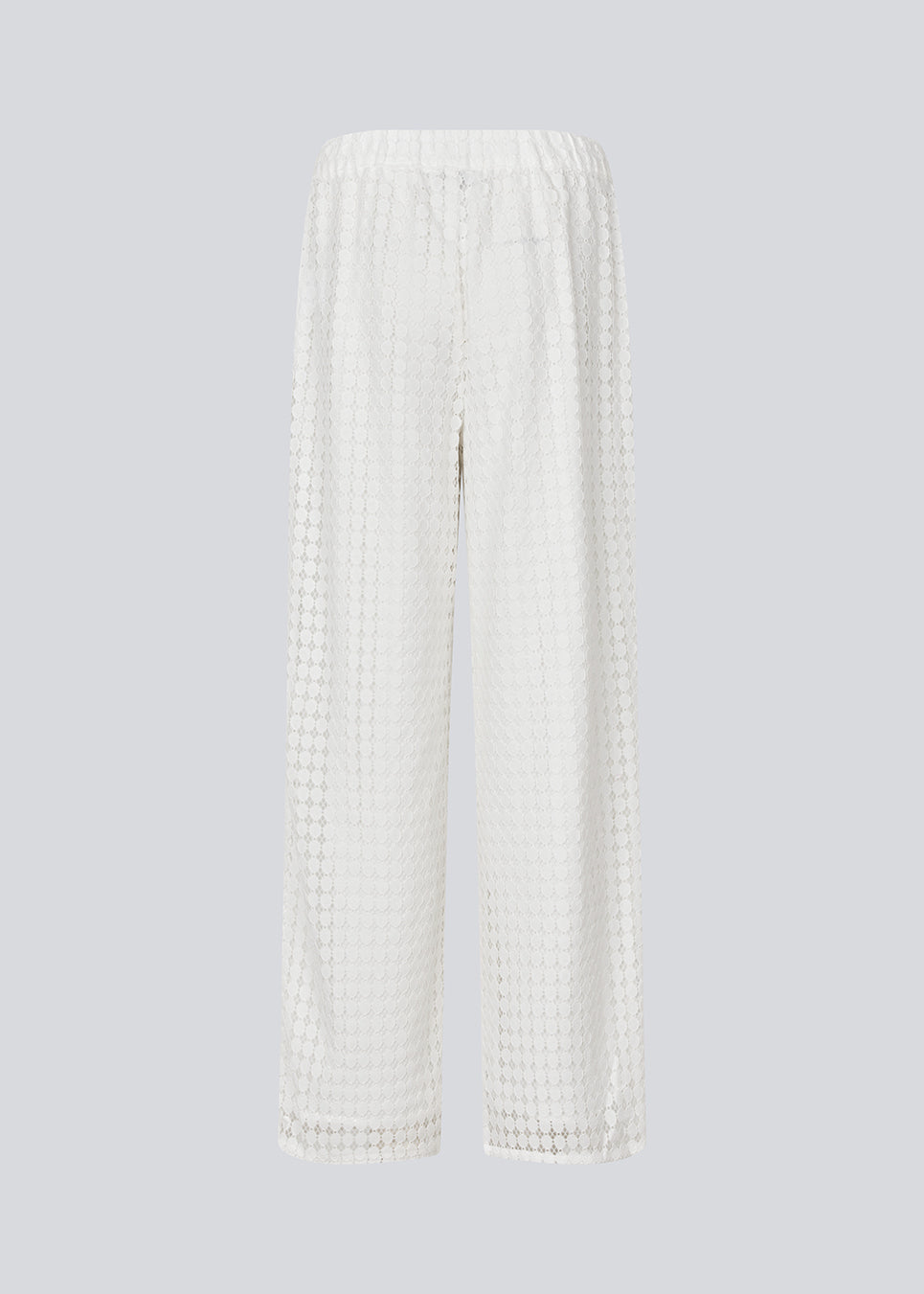 HattieMD pants in white are made from a transparent lace material. The pants have a loose fit with straight legs and a medium elasticated waist. Lined. The model is 175 cm and wears a size S/36.