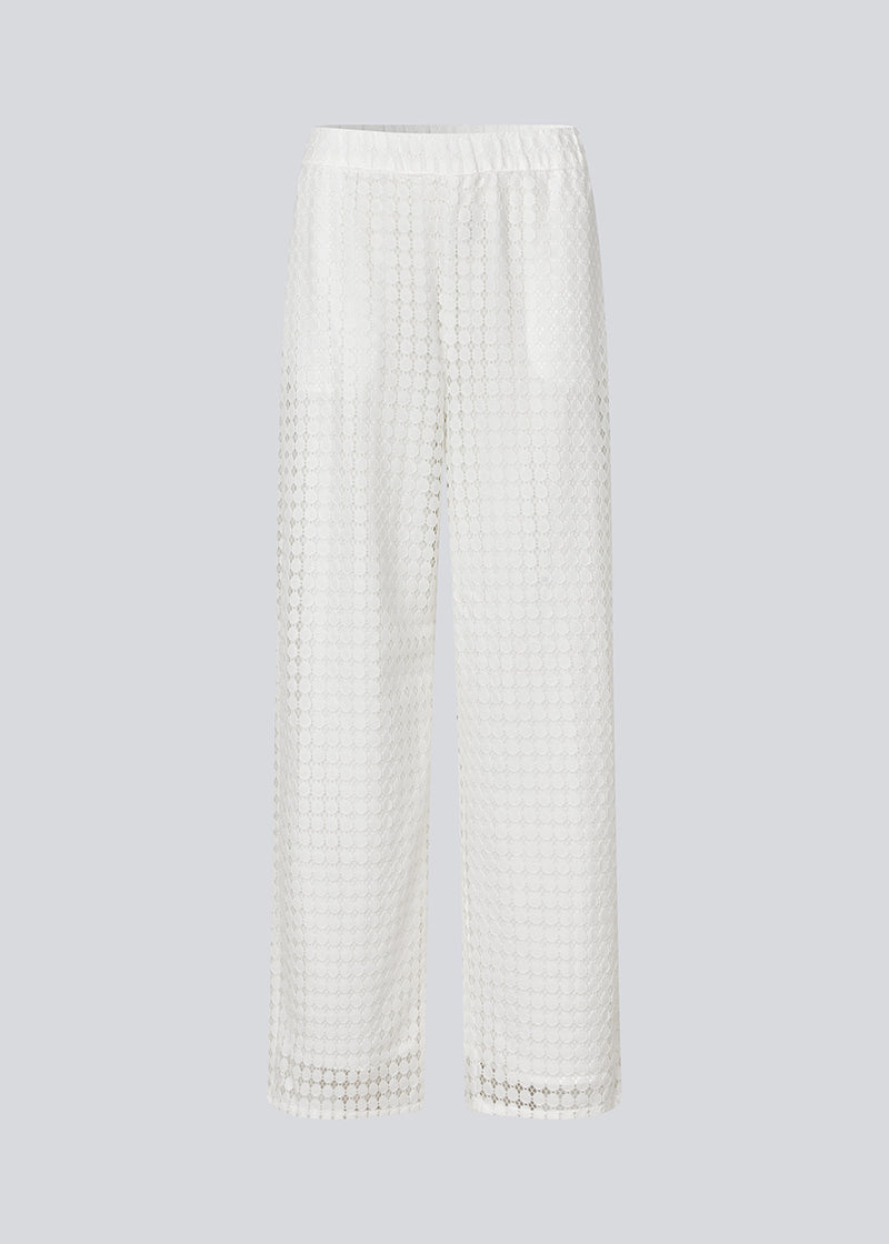 HattieMD pants in white are made from a transparent lace material. The pants have a loose fit with straight legs and a medium elasticated waist. Lined. The model is 175 cm and wears a size S/36.