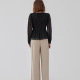 Top in black in a slightly transparent lace quality. HattieMD top has a v-neckline with button closure in front, long balloon sleeves, and a peplum-shaped waist. The model is 175 cm and wears a size S/36.