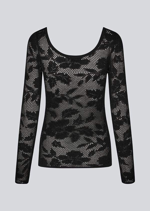 Tight-fitting top in black in a stretchy lace material, that is slightly see-through. HawkinsMD top has long sleeves, and a deep neckline in front and back. 