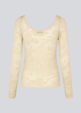 Tight-fitting top in beige in a stretchy lace material, that is slightly see-through. HawkinsMD top has long sleeves, and a deep neckline in front and back. 
