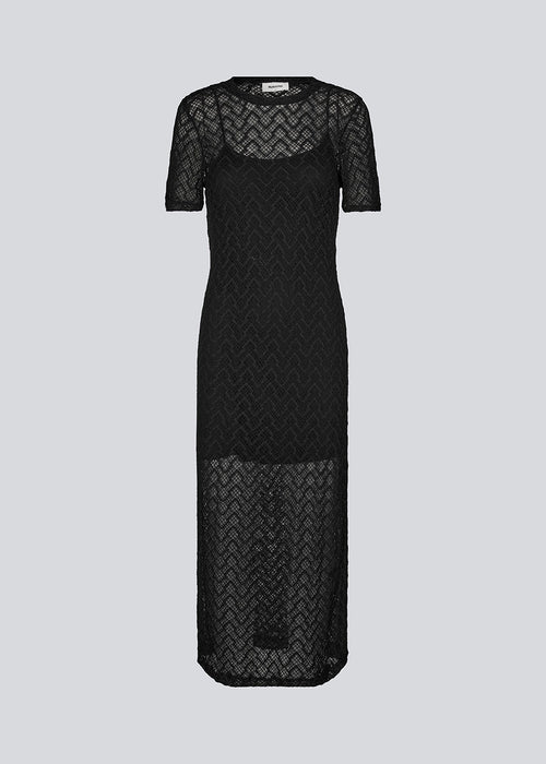 Midi dress in black in a patterned, transparent material. HendrickMD dress has a round neck and short sleeves. Slip dress with thin straps is included. The model is 175 cm and wears a size S/36.