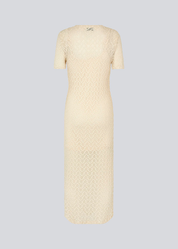 Midi dress in bright beige in a patterned, transparent material. HendrickMD dress has a round neck and short sleeves. Slip dress with thin straps is included.&nbsp;
