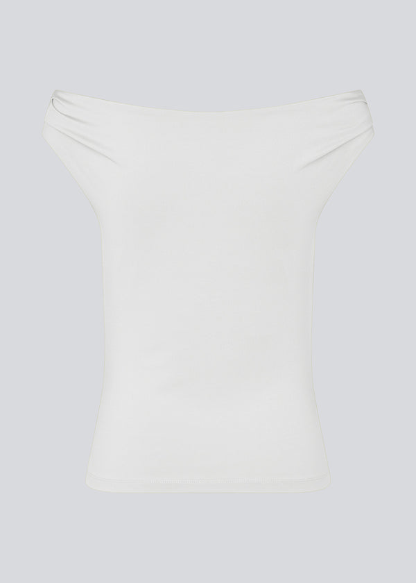 Off-shoulder top in white in a stretchy material. HimaMD off-shoulder top is fitted and slightly cropped.