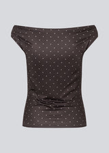 Off-shoulder top in dark brown with white small dots in a stretchy material. HimaMD off-shoulder top is fitted and slightly cropped.&nbsp;
