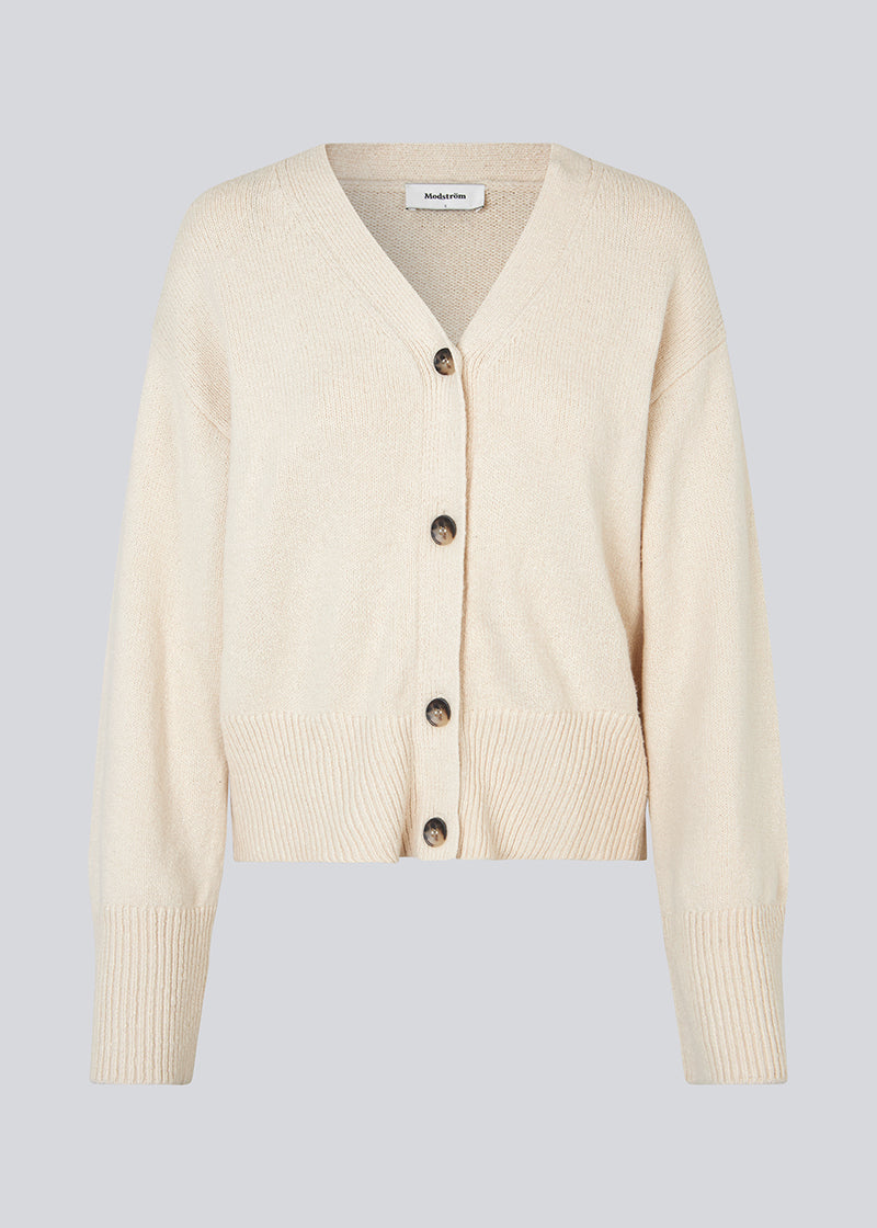 Cardigan in beige in knitted cotton blend. HimmaMD cardigan has a relaxed fit with a v-neckline, buttons in front, and dropped shoulders. Wide rib trimmings at cuffs and hem. 