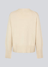 Knit jumper in beige in a cotton blend. HimmaMD cardigan has a relaxed silhouette with a round neck, dropped shoulders, and slits at cuffs. Wide rib trimmings at the neck, cuffs and hem. 