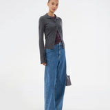 Dark grey fitted cardigan made from a soft, rib-knitted wool. HirokiMD cardigan has a collar, buttons in front, and long sleeves with slit and buttons. The model is 175 cm and wears a size S/36.