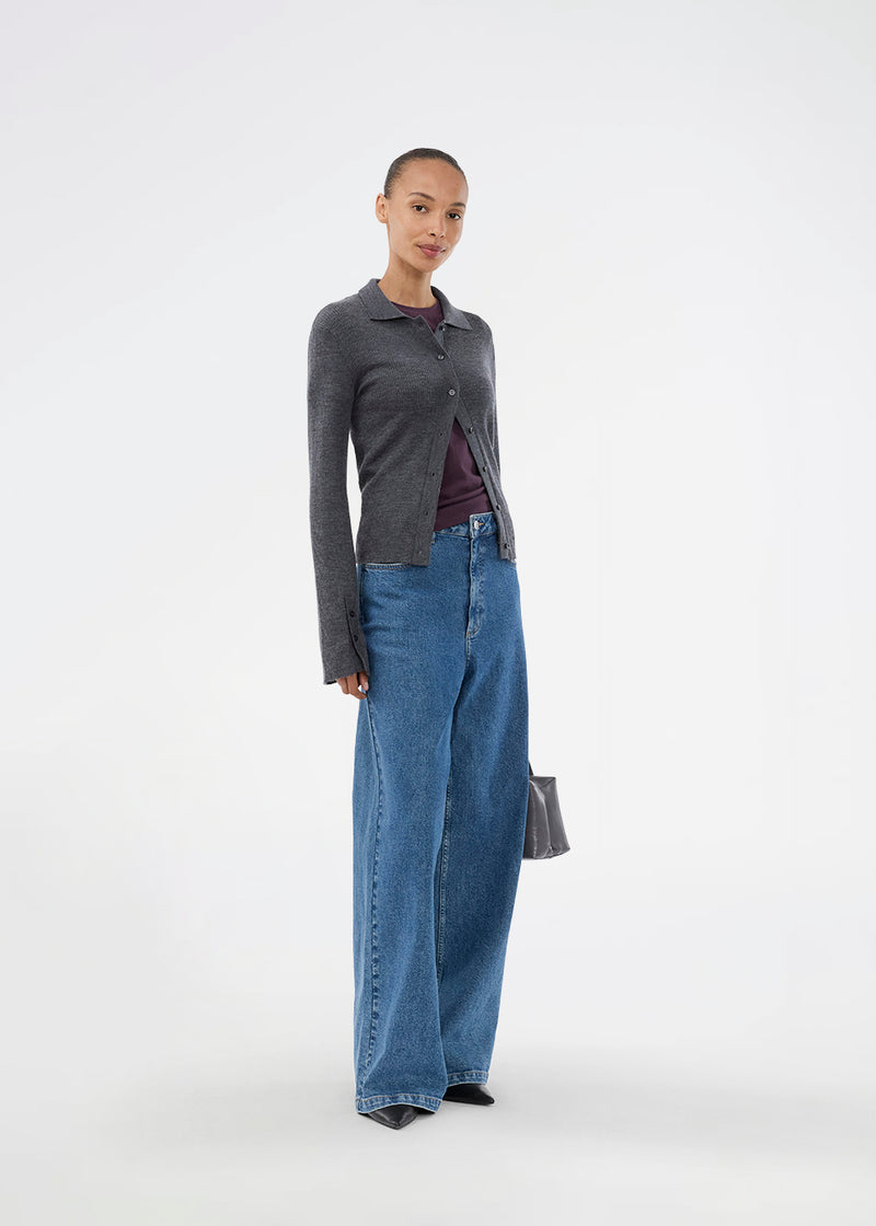Dark grey fitted cardigan made from a soft, rib-knitted wool. HirokiMD cardigan has a collar, buttons in front, and long sleeves with slit and buttons. The model is 175 cm and wears a size S/36.
