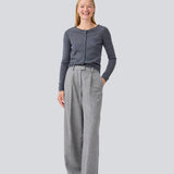 Fitted grey cardigan in soft knit. HirokiMD short cardigan has a round neck and a button closure in front. The model is 177 cm and wears a size S/36.