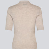 Short-sleeved polo in beige made from 100% rib-knit wool. The HirokiMD SS Polo combines timeless elegance with relaxed comfort. The soft, ribbed texture drapes beautifully on the body, while the collar and button closure allow you to adjust the look. The model is 175 cm and wears a size S/36.


Material:
100% Wool