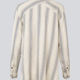 Oversize shirt with collar and button closure in front. HissaMD print shirt has wide sleeves with cuff, and a detailed yoke at the back. 