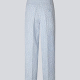 Pants in a light blue color with straight legs in a structured material. HollisMD pants have a medium waist with a hidden zipper at one side, and two welt pockets on the back.
