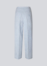 Pants in a light blue color with straight legs in a structured material. HollisMD pants have a medium waist with a hidden zipper at one side, and two welt pockets on the back.