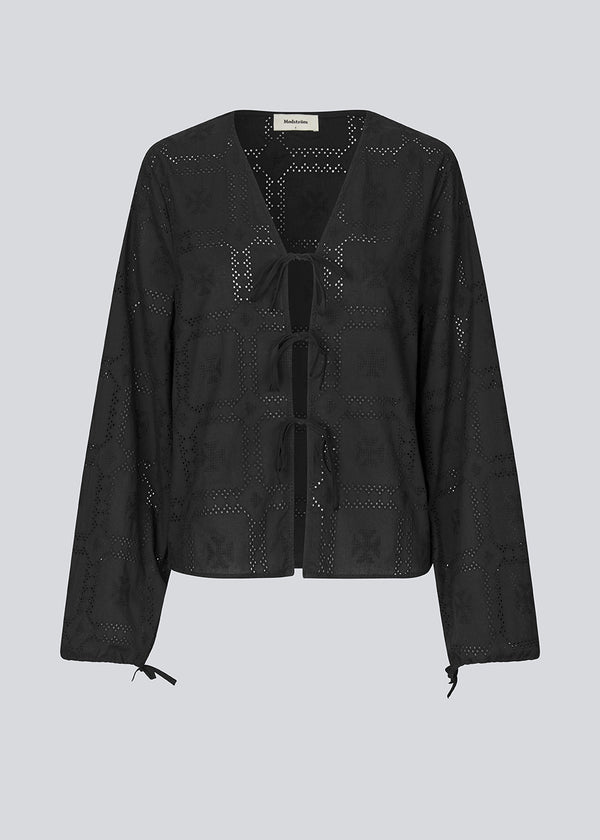 Broderie anglaise cotton shirt in black with three tiebands in front. HollynMD shirt has a normal fit and long wide. sleeves with a tieband at the end.