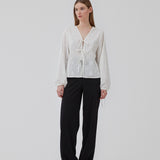 Broderie anglaise cotton shirt in white with three tiebands in front. HollynMD shirt has a normal fit and long wide. sleeves with a tieband at the end. The model is 176 cm and is wearing size S/36.