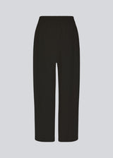 Pants in black designed with a casual look and fit in a cotton and linen blend. HonorMD pants has loose legs and a medium waist with a wide elastic band.