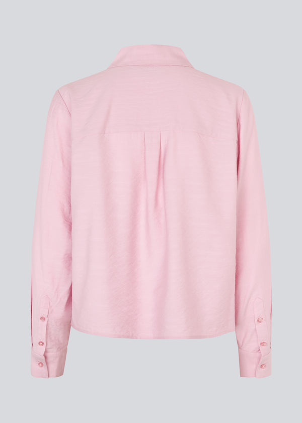Shirt in light pink/rosa in a light EcoVero viscose with a loose fit. HudgesMD shirt has a collar, button closure in front, and long sleeves with cuffs.&nbsp;