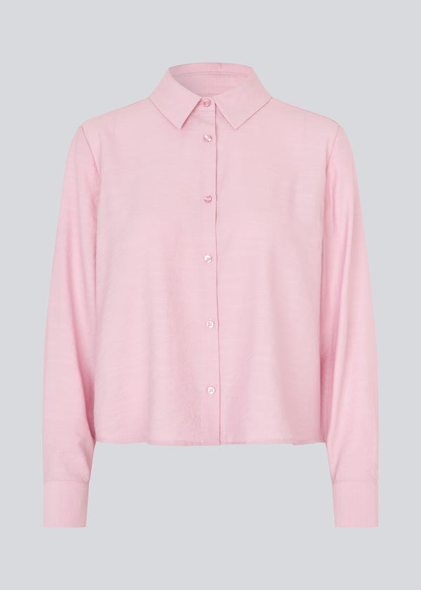 Shirt in light pink/rosa in a light EcoVero viscose with a loose fit. HudgesMD shirt has a collar, button closure in front, and long sleeves with cuffs.&nbsp;