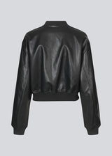 Short, padded bomber jacket with a small, ribbed collar and zipper in front. The jacket is short/cropped. Relaxed fit with dropped shoulders, discreet front pocket and slanted side pockets. Ribbing at cuffs and hem.