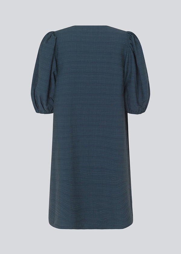 Midi dress in dark blue in a loose fit with a V-neckline. IbiMD flare dress has puff sleeves with an elastic at the end.