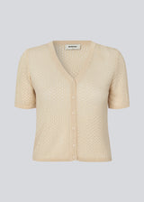Knitted short-sleeved cardigan in beige in a loose fit. IggyMD cardigan is in slightly see-through and has a V-neckline and rib knit on the hem.