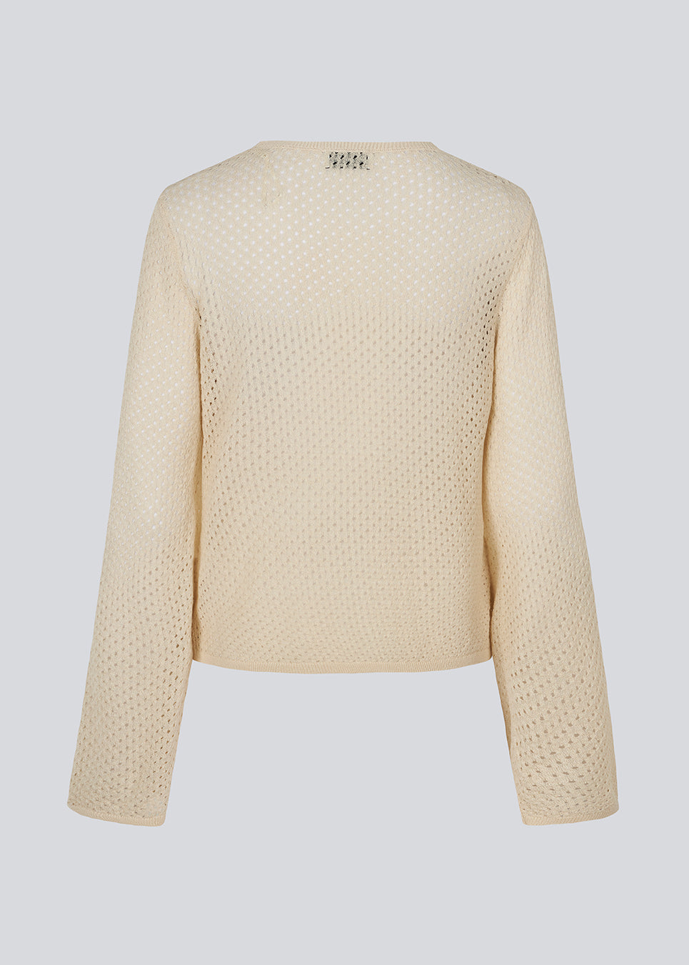 Beige long sleeved light knit with a loose fit. The IggyMD o-neck is in a knitted material which is slightly see-through. 