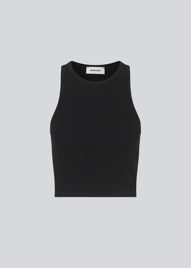 Basic top cut from a soft ribbed jersey fabric. IgorMD crop top in the color Black is styles with a slim fit and cropped fit with racer-shaped back. Perfect for a sporty look. The model is 173 cm and wears a size S/36
