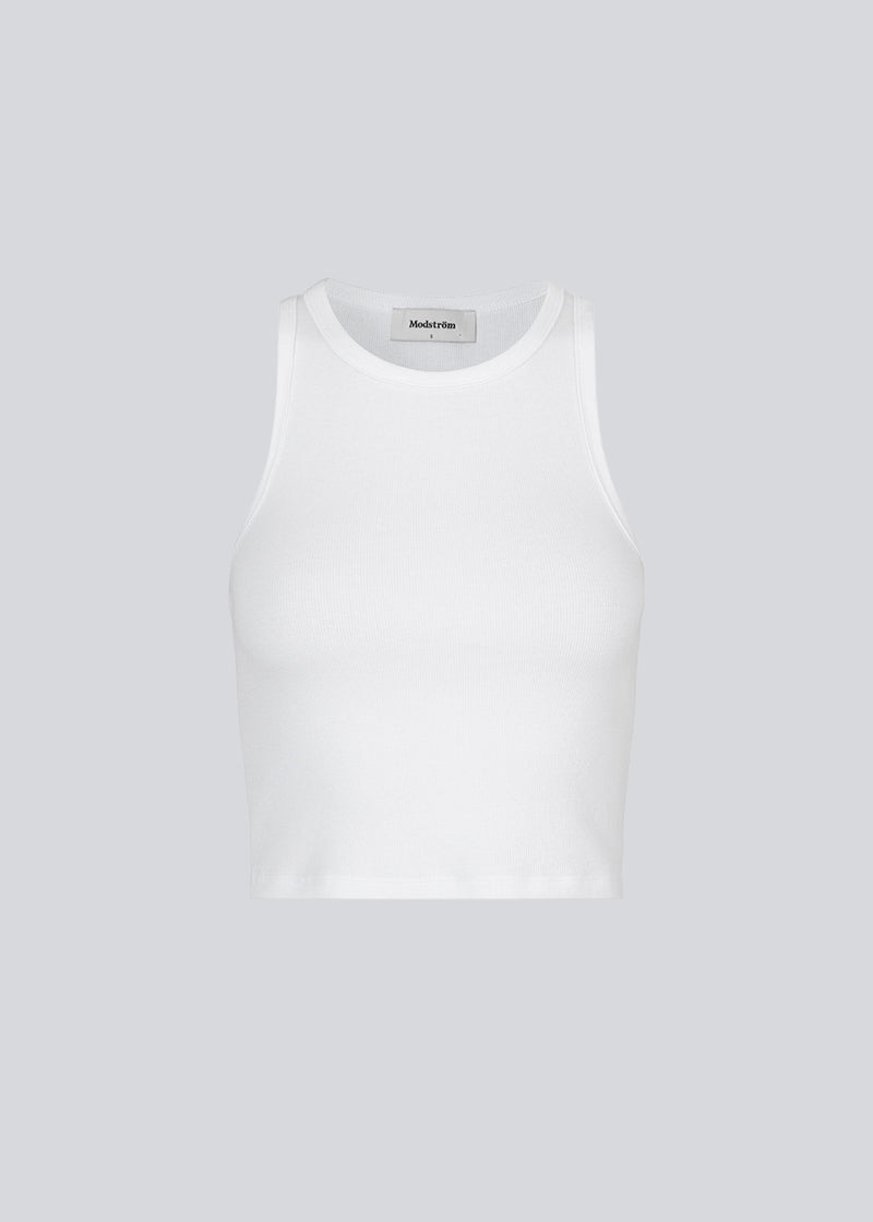 Basic top cut from a soft ribbed jersey fabric. IgorMD crop top in the color Off White is styled with a slim fit and cropped fit with racer-shaped back. Perfect for a sporty look. The model is 173 cm and wears a size S/36