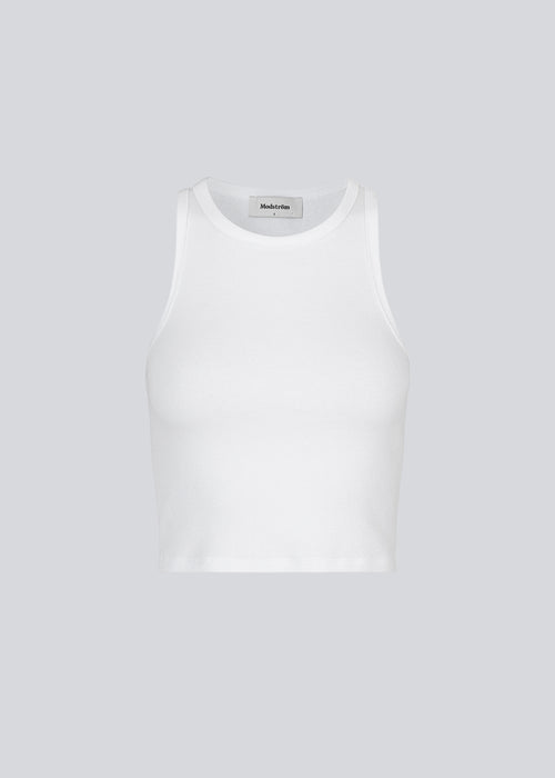 Basic top cut from a soft ribbed jersey fabric. IgorMD crop top in the color Off White is styled with a slim fit and cropped fit with racer-shaped back. Perfect for a sporty look. The model is 173 cm and wears a size S/36