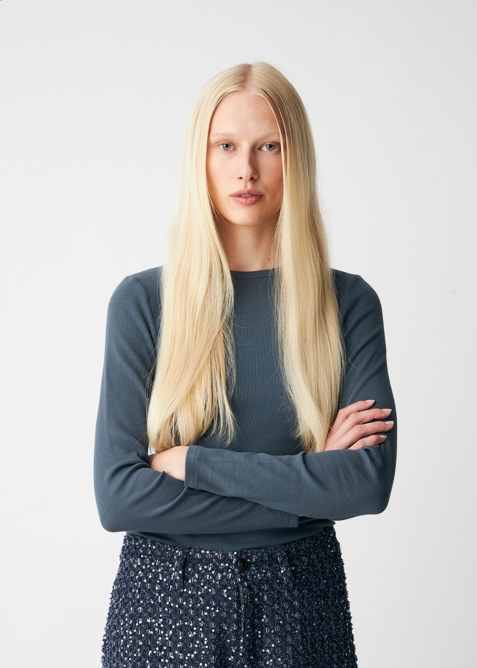 Soft, fitted long-sleeved T-shirt, made from organic cotton rib with stretch and finished with a round neckline. Layer it beneath tailoring or wear it with wide-leg trousers.
 
