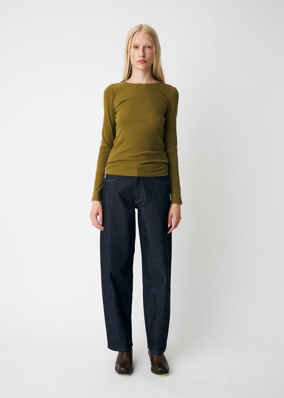 Soft, fitted long-sleeved T-shirt, made from organic cotton rib with stretch and finished with a round neckline. Layer it beneath tailoring or wear it with wide-leg trousers.
 