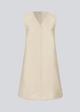 Short sleeveless dress in linen and cotton. IngridMD dress has a v-neckline and raw edges in front and at the bottom.<br>