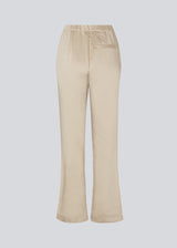 Flared pants in satin with an elastic in the back. IolaMD pants have a high waist, side pockets and a paspoli back pocket.