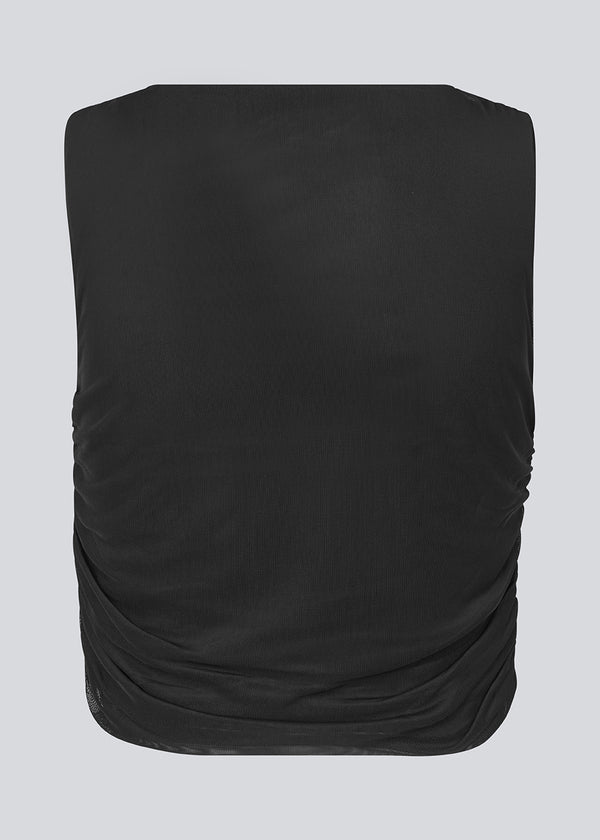 Cropped fitted top in an elastic material. IrvinMD dress has a gathering at the top and in the side seams.