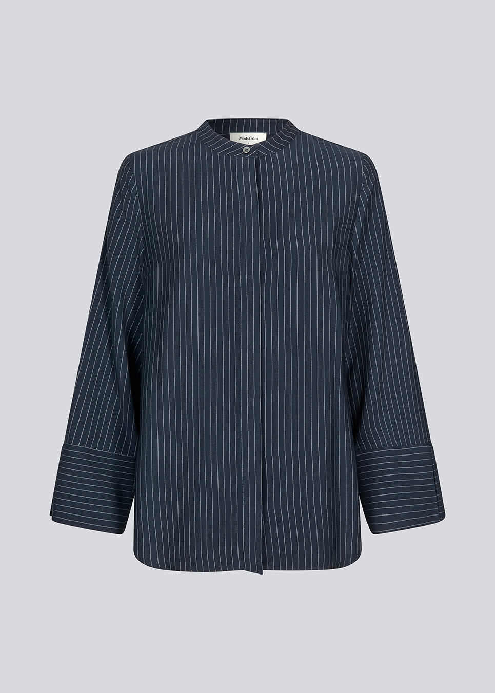 Navy shirt with copped sleeves and a slit. IsabelMD shirt has a hidden button closure and a high neck.